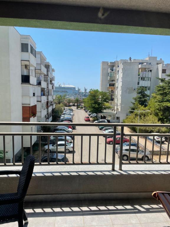 a balcony with a view of a parking lot with cars at Seaview Apartment in Bar