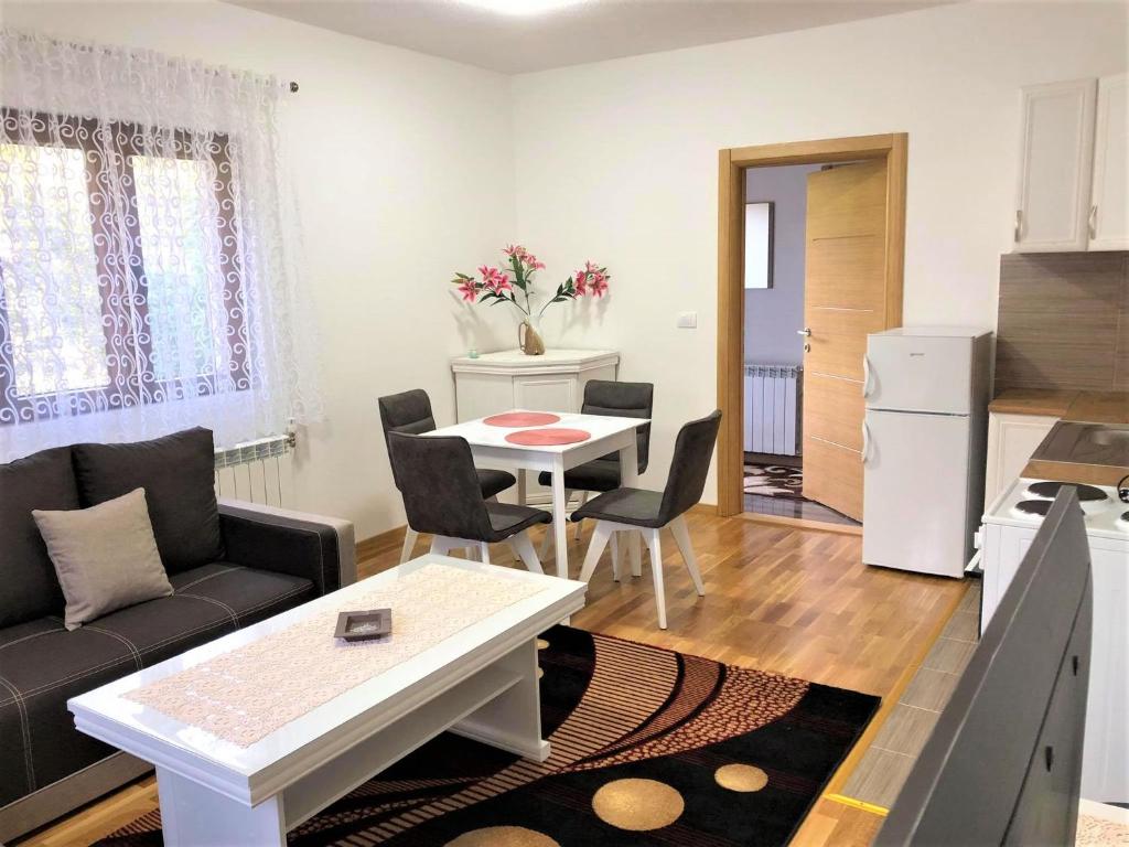 a living room with a couch and a table at Apartman Lalica in Kolašin