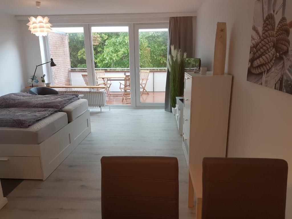 a bedroom with a bed and a view of a balcony at Eckernförde Baltic Beach in Eckernförde