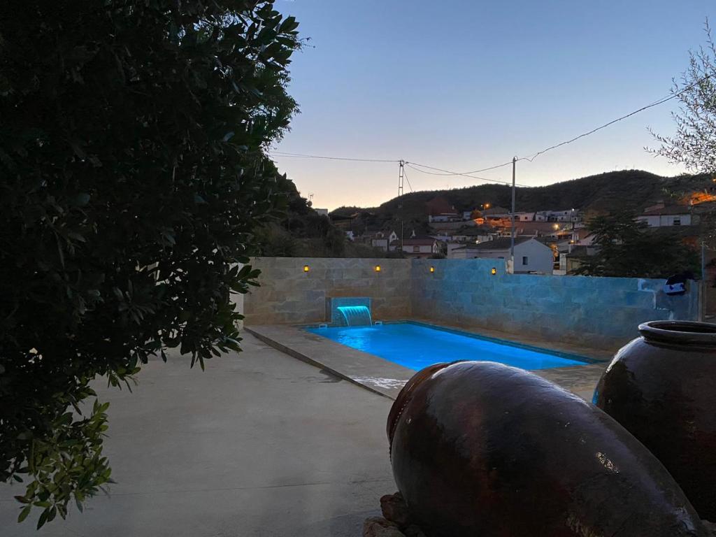 a swimming pool in a yard with aphalt at Cuevas Uropia in Graena