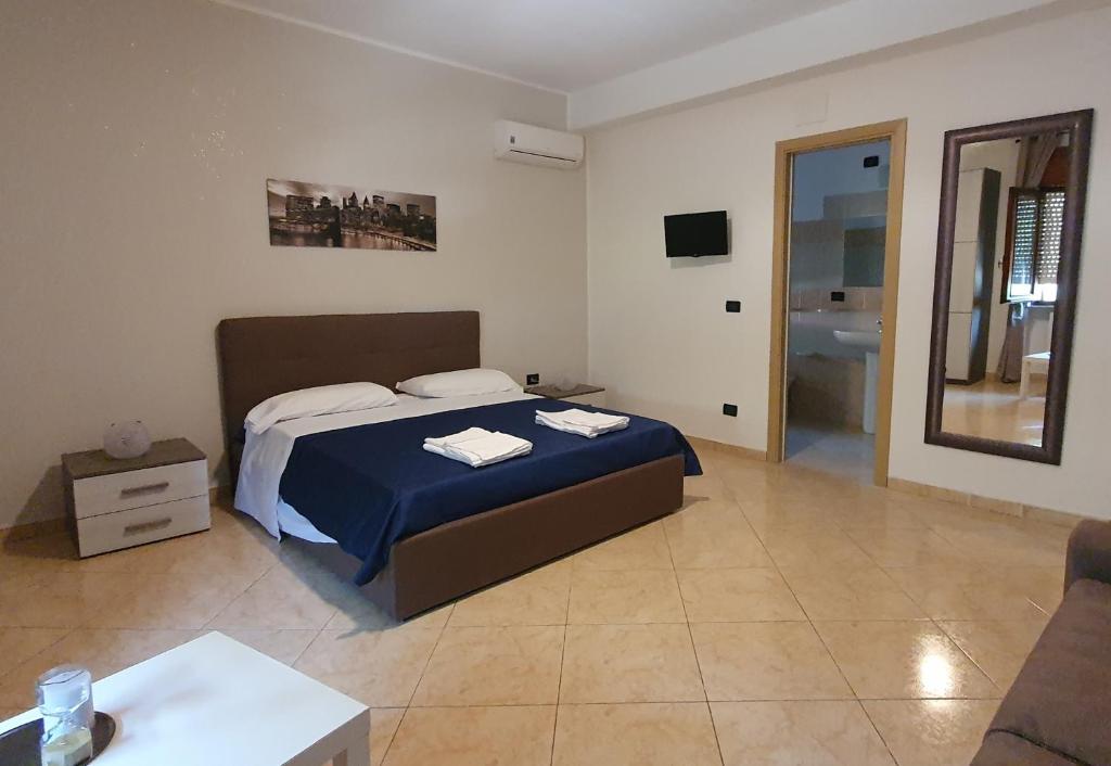 サンタ・マリーア・デル・チェドロにあるB&B Caput Mundi-Calabriaのベッドルーム(ベッド1台、ソファ、テレビ付)
