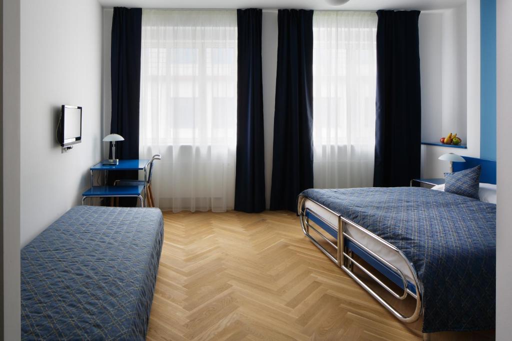 Łóżko lub łóżka w pokoju w obiekcie AXA Hotel