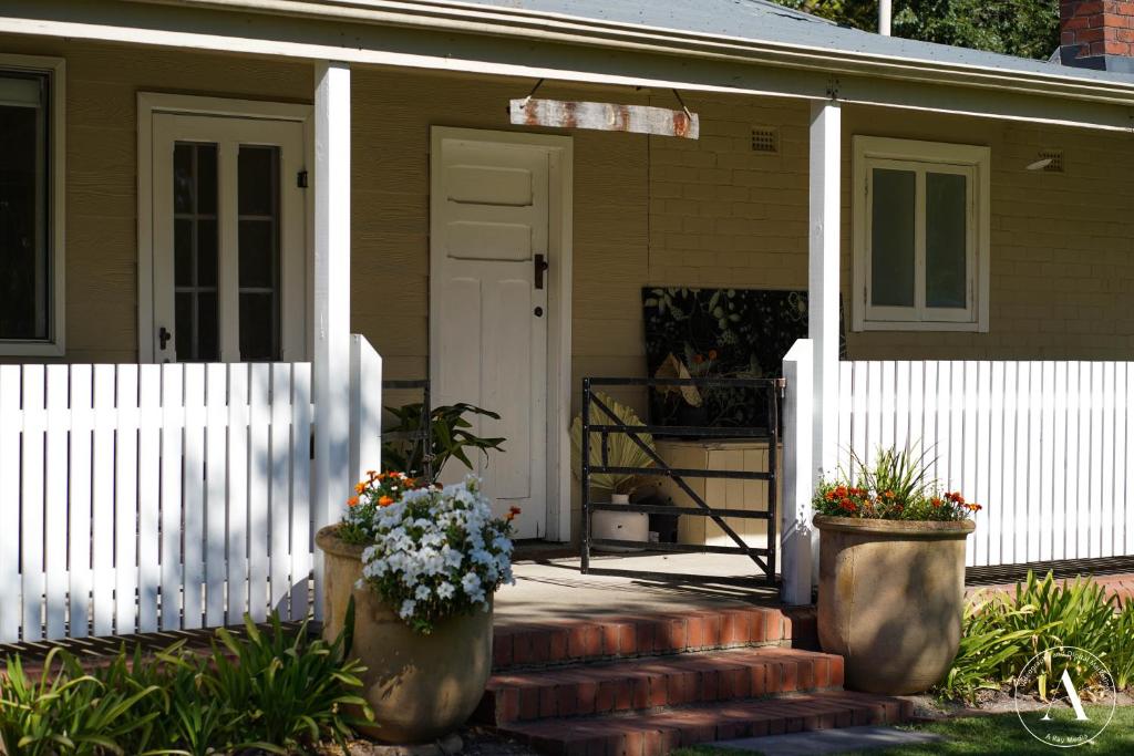 a house with two flower pots on the front porch at Barristers Block Wines Vigneron Villa in Woodside