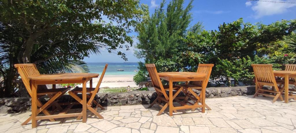 a group of chairs and tables on the beach at Bara Beach Bungalows in Bira