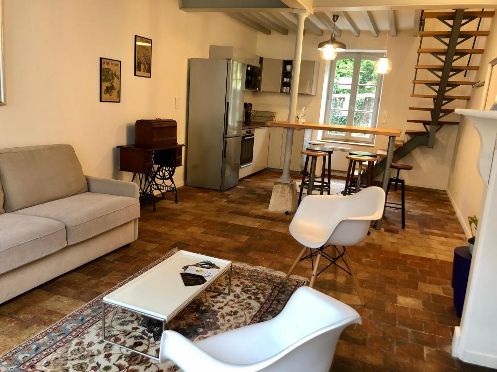 a living room with a couch and a table at Taboo Treigny in Treigny