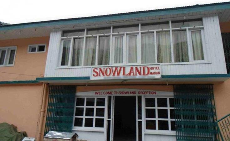 a building with a snow land sign in front of it at Snow Land Guest House Naran in Nārān