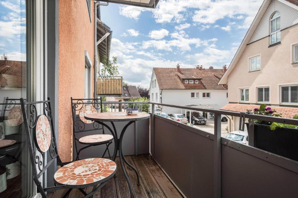 a balcony with a table and chairs and a view at Freyzeit in Kressbronn am Bodensee