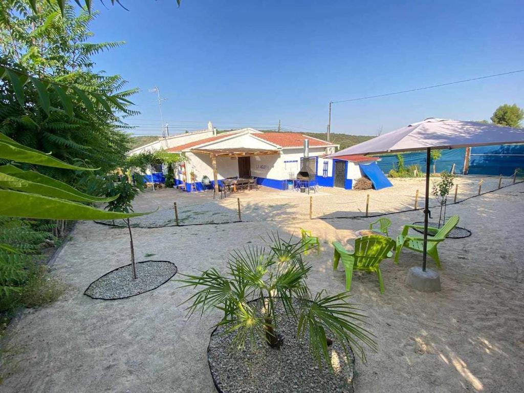 a patio with chairs and tables and a building at Casa Rural La Higuera in Ruidera