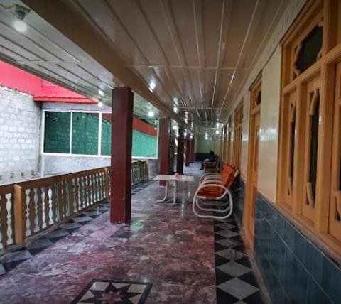 a hallway with chairs and tables on a building at Green Hill Hotel Thall Kumrat in Tāl