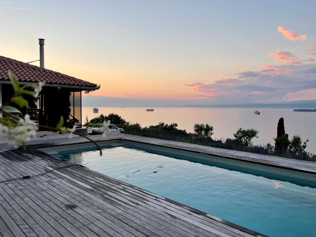 a swimming pool with a view of the water at Villa The View in Koper