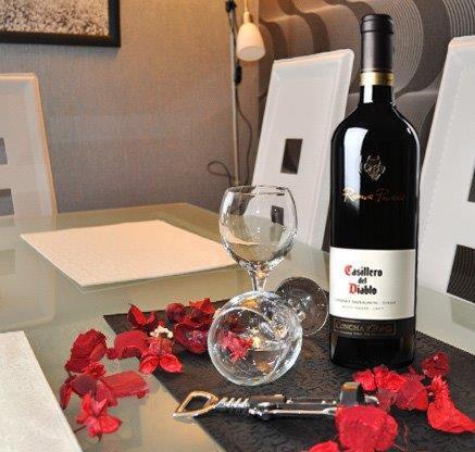a bottle of wine and a glass on a table at Lux apartment A38, Kraljevi čardaci, Kopaonik in Kopaonik