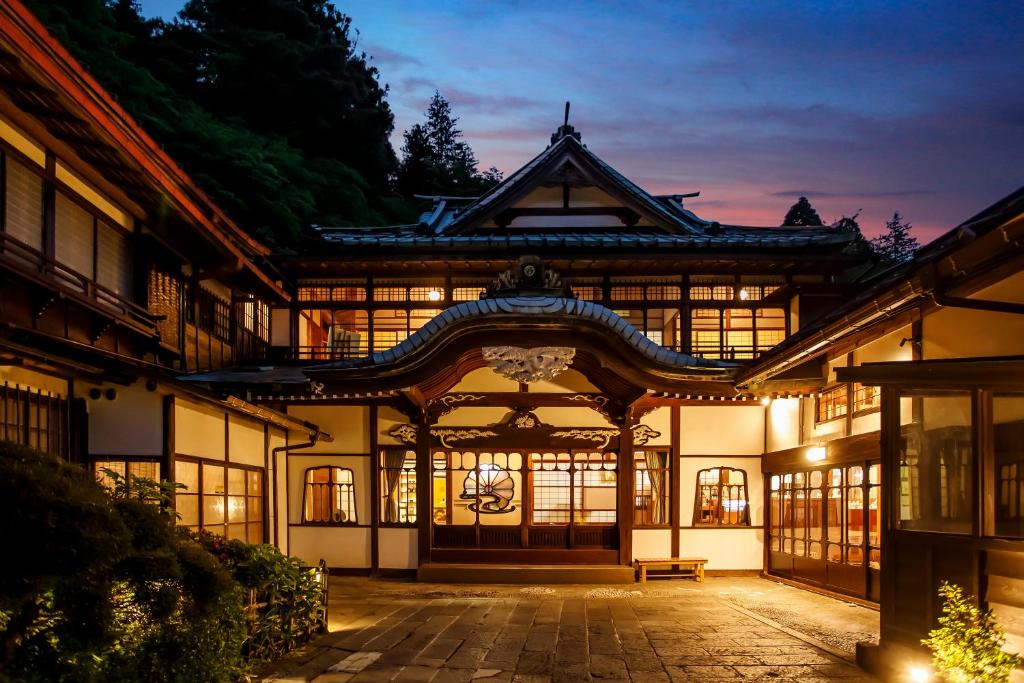 an exterior of a building with a lit up facade at Hakone Kowakien Mikawaya Ryokan in Hakone