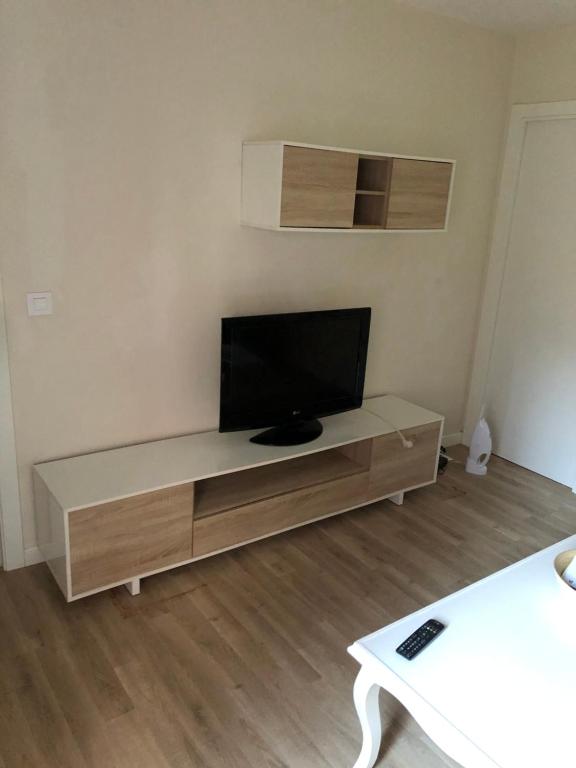 a living room with a flat screen tv on a cabinet at San Andrés, 93 Apartamento in A Coruña