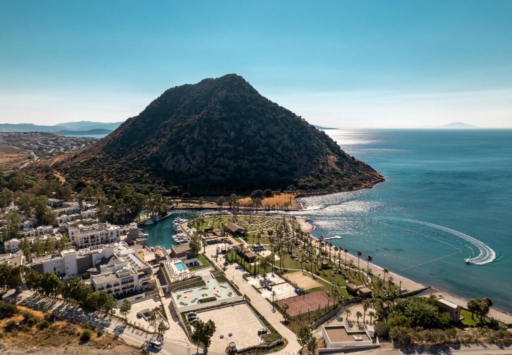 an aerial view of a beach with a mountain at Radisson Collection Hotel, Bodrum in Akyarlar