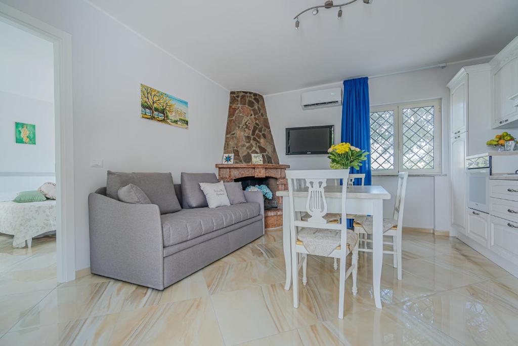 a living room with a couch and a table at Stabiaeflor Apartment in Castellammare di Stabia