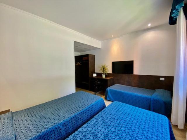 Postel nebo postele na pokoji v ubytování Hotel Garibaldi