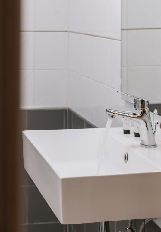 a white sink in a bathroom with a mirror at Amalia in Matala