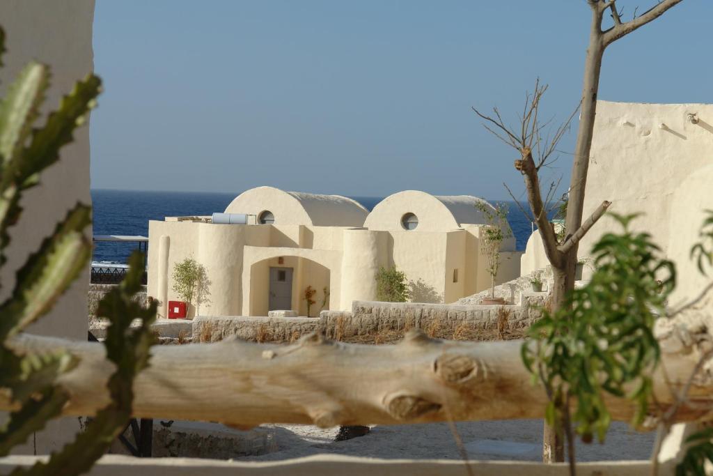 a view of a building with the ocean in the background at The Oasis in Abu Dabbab