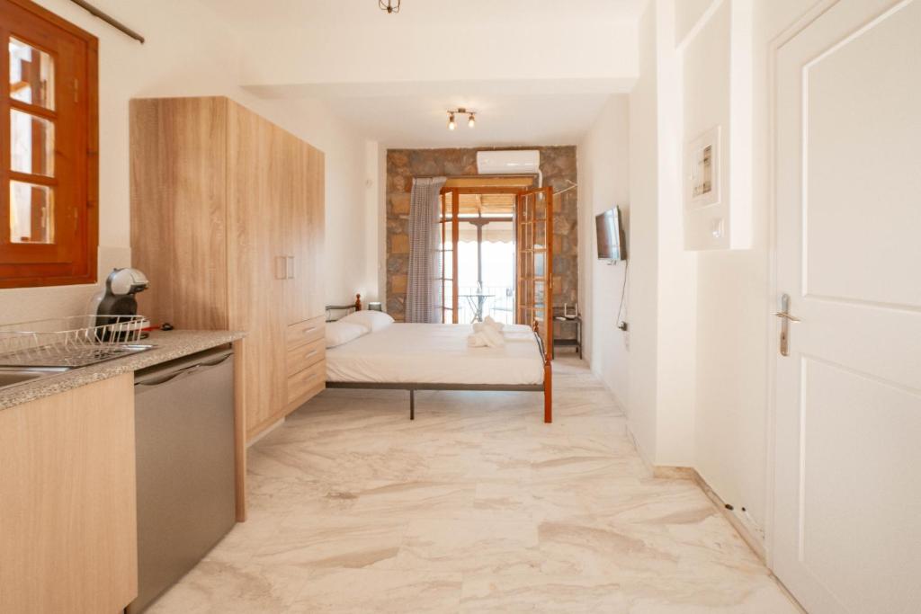 a kitchen with a bed in the middle of a room at Evimeria Kalamata in Kalamata
