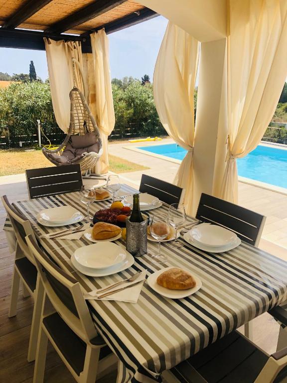 a table with plates of food on top at Villa Melissa in Tertenìa