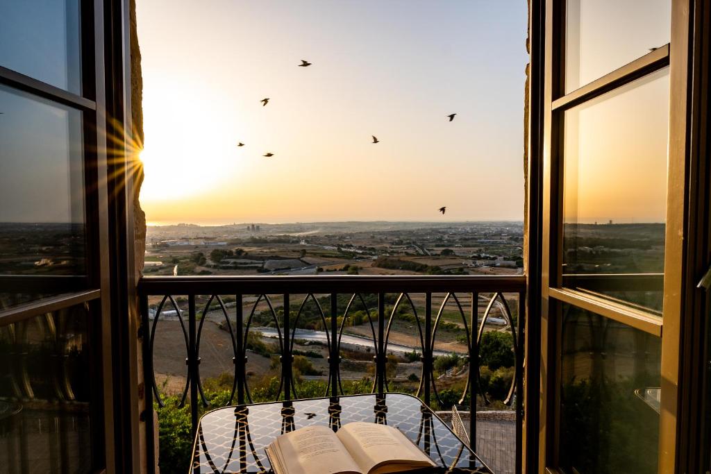 a view from a window with books on a table at The Xara Palace Relais & Chateaux in Mdina