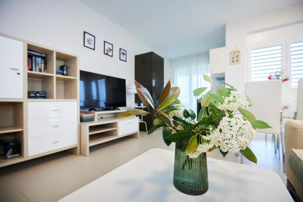 a vase of flowers on a table in a living room at Villa Grdelina in Supetar