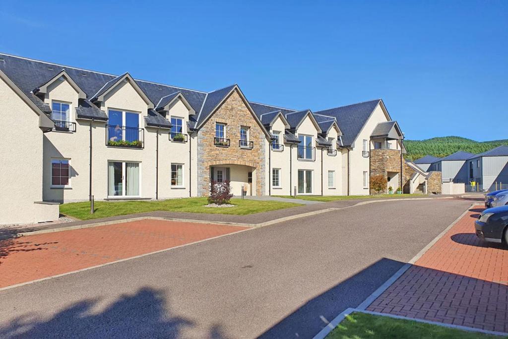 a row of houses on a street at The Steading Apartment in Aviemore