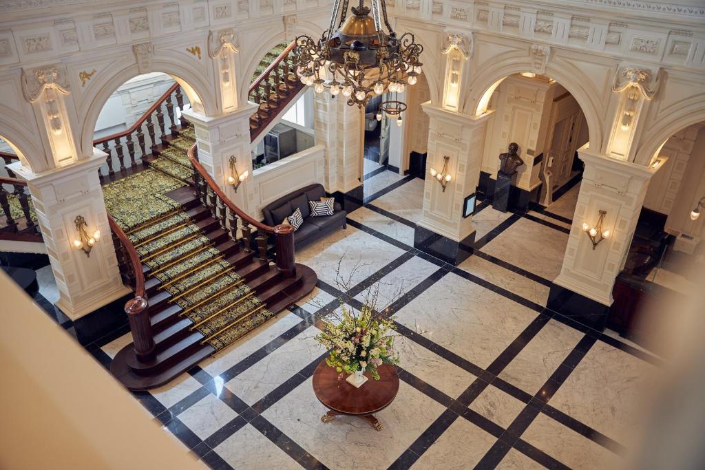 an aerial view of a building with stairs and a chandelier at InterContinental Amstel Amsterdam by IHG in Amsterdam