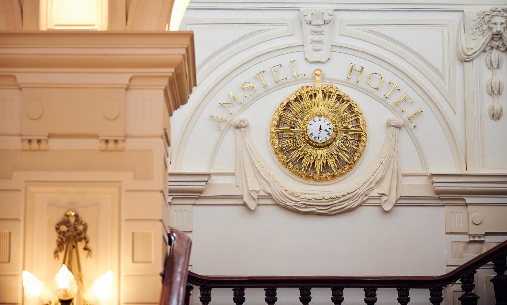 a clock on the wall of a building at InterContinental Amstel Amsterdam by IHG in Amsterdam