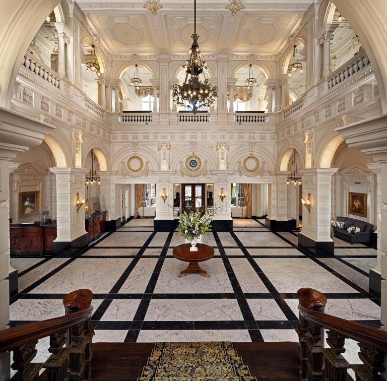 a large building with a large lobby with a chandelier at InterContinental Amstel Amsterdam by IHG in Amsterdam