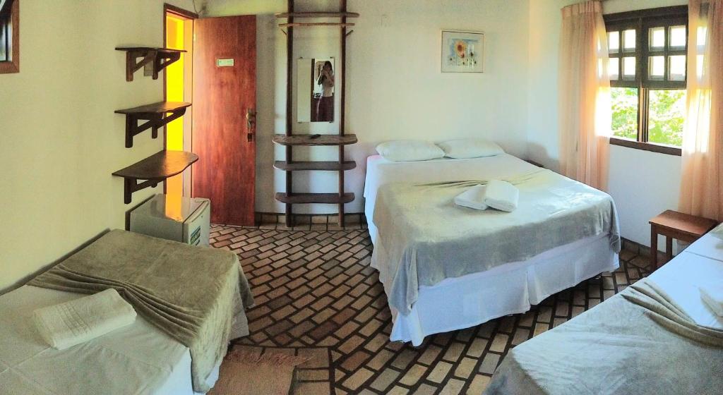 Cama ou camas em um quarto em Pousada Alto do Cajueiro