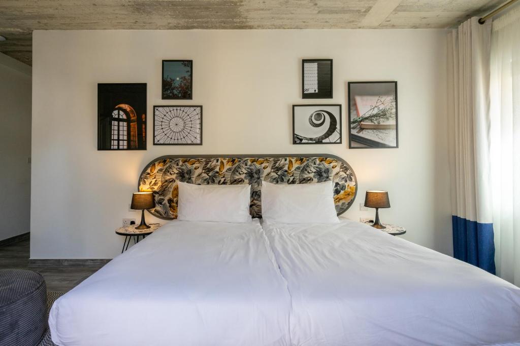 a bedroom with a large white bed with two pillows at Lady Todd in Sliema