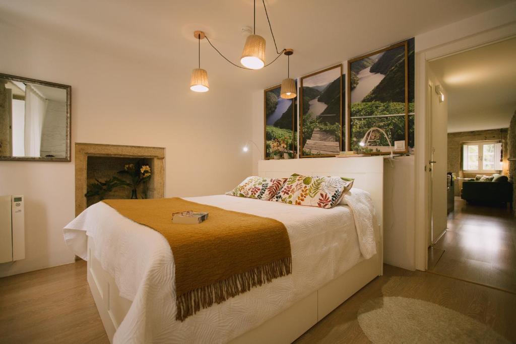 a bedroom with a large bed with two pillows at roomPEDRA apartamentos turísticos in Santiago de Compostela