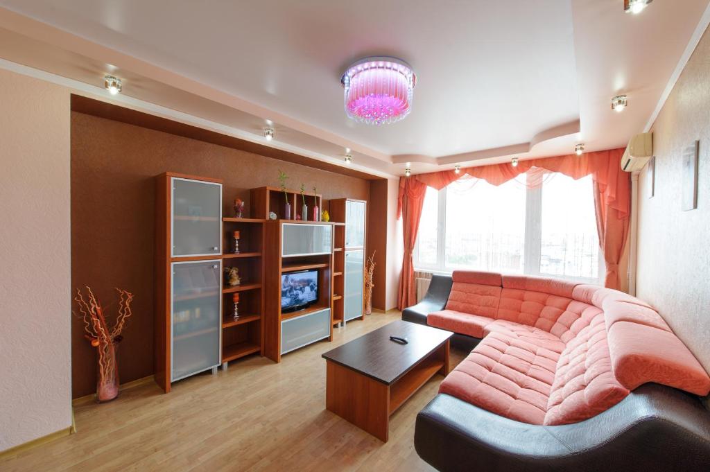 a living room with a couch and a television at Nice Flats Noviy Arbat in Moscow