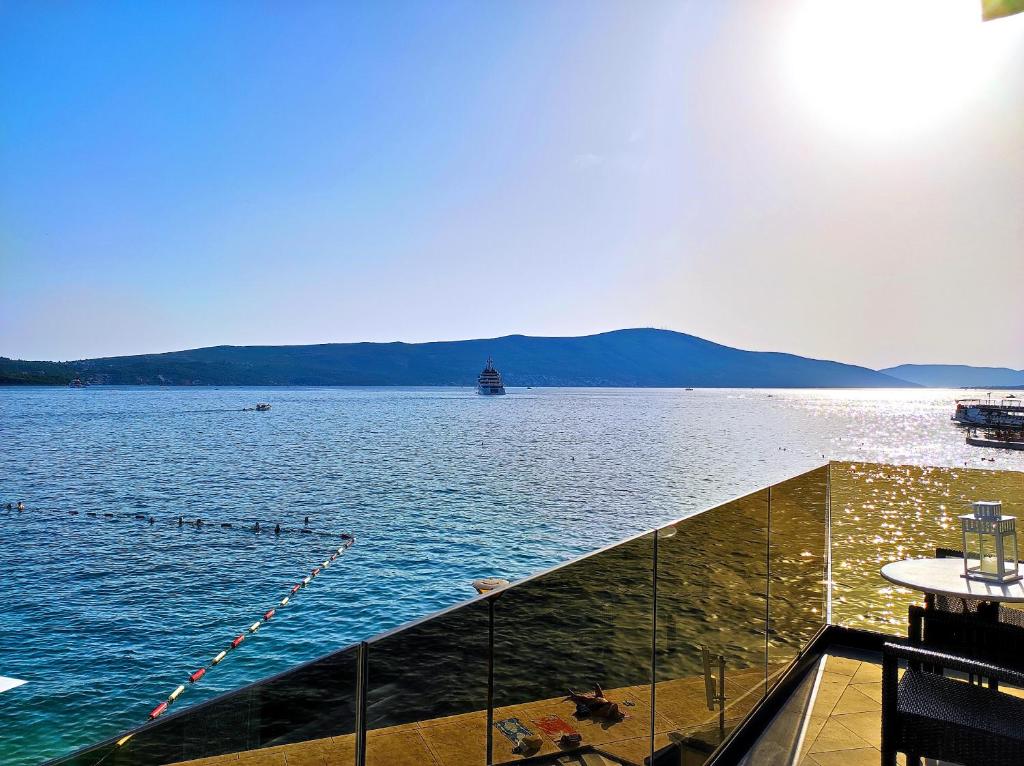a view of a large body of water with a boat at Seafront apartments in Tivat