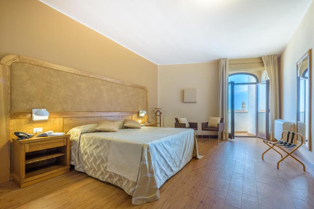 A bed or beds in a room at Leone de Castris Wine Hotel