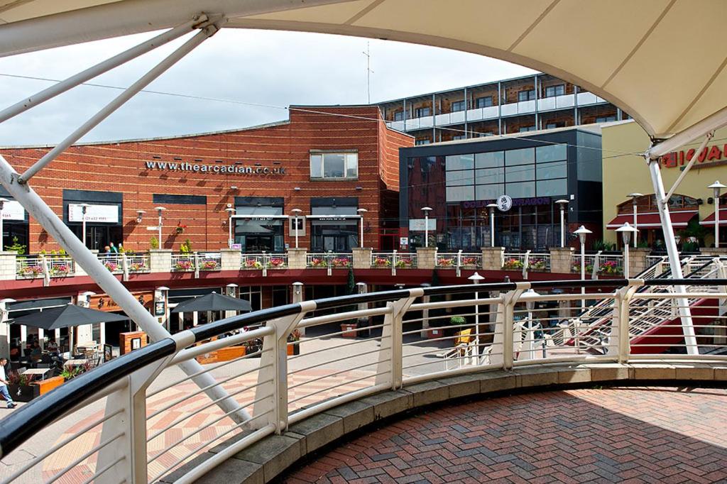 a bridge over a walkway in front of a building at Arcadian Aparthotel in Birmingham