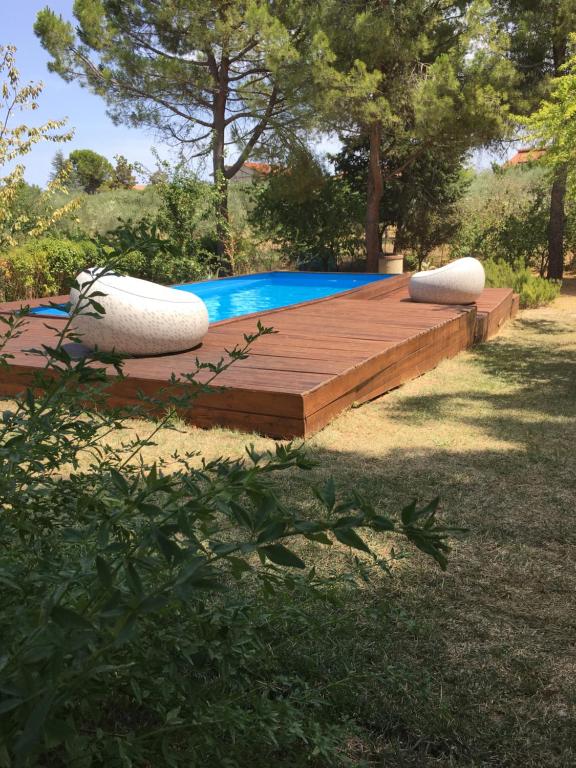 a pool with two pillows on a wooden deck at La villa più bella con piscina in Treglio