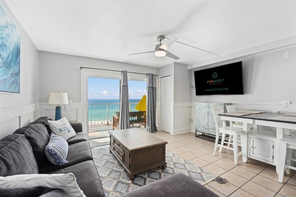 a living room with a couch and a table with a view of the ocean at The Summit 624 in Panama City Beach