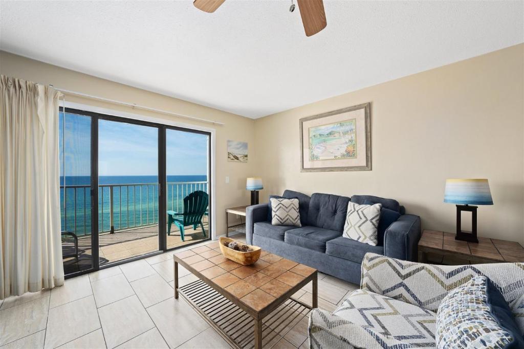 a living room with a couch and a view of the ocean at The Summit 1011 in Panama City Beach