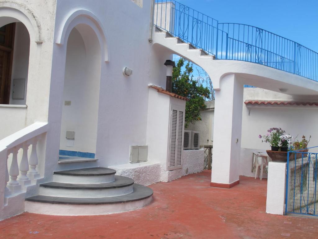 a stairway leading to a white building with a staircase at Aparthotel Villa Marinù in Ischia