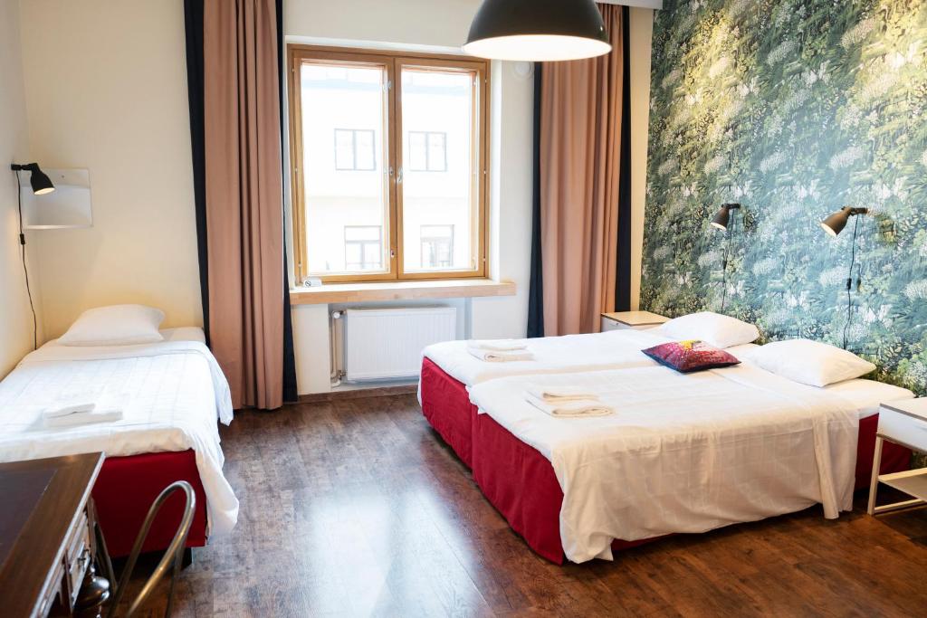 Postel nebo postele na pokoji v ubytování Hotel Finn