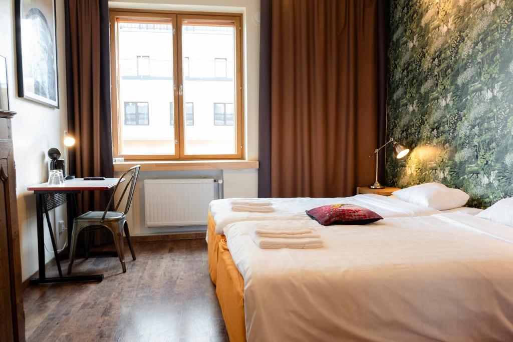 Postel nebo postele na pokoji v ubytování Hotel Finn