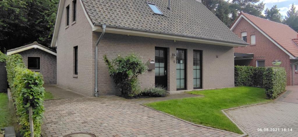 a house with a brick driveway in front of it at De hümmelske Bur in Friesoythe