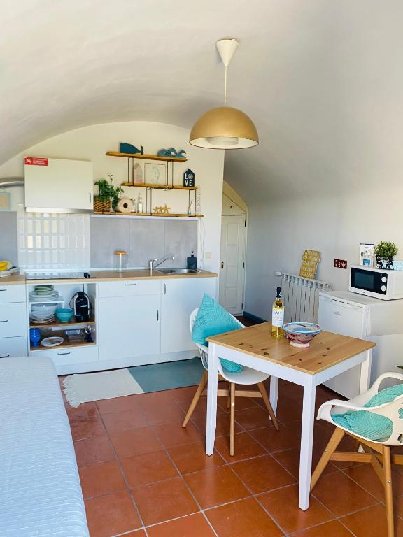 a kitchen and dining room with a table and chairs at Beach House Loft in Cortegaça