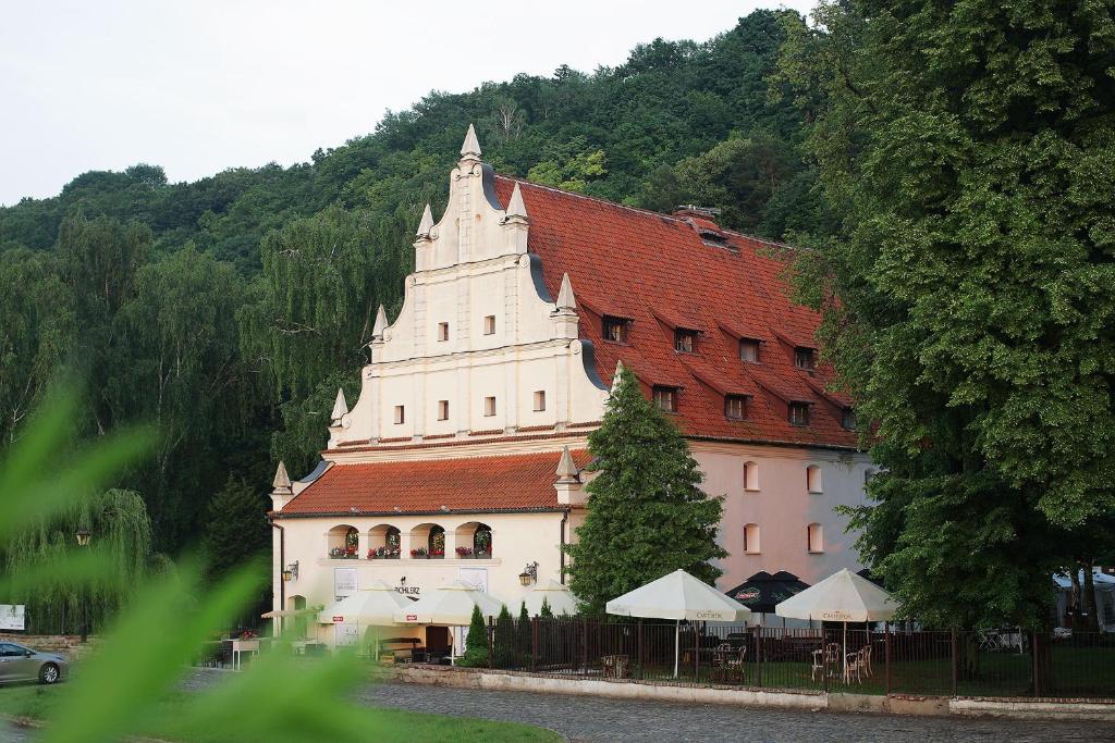 a large white building with a red roof at Spichlerz na Krakowskiej in Kazimierz Dolny