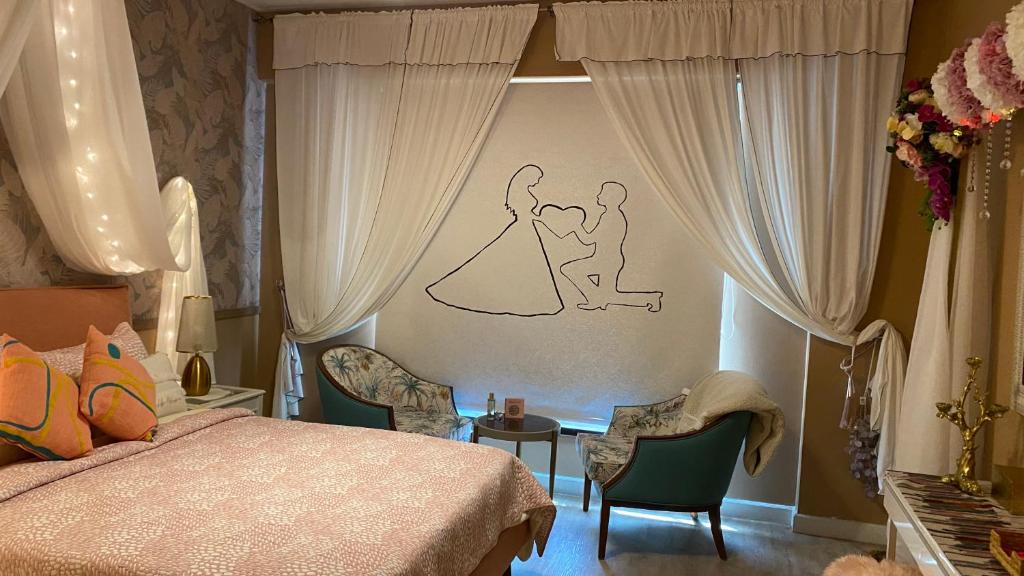 a bedroom with a bride and groom drawing on the wall at B-LBAIT KAEC Honeymoon Style for family in King Abdullah Economic City