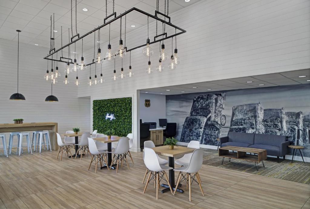 a lobby with tables and chairs and a couch at Atrea Inn Amarillo in Amarillo