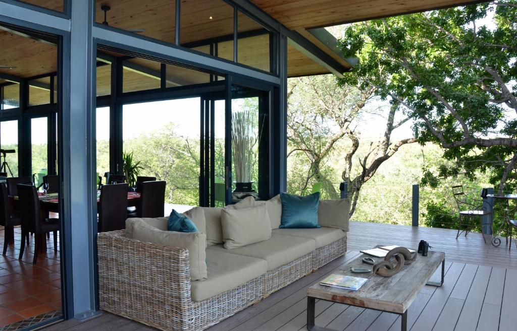 a living room with a couch and a table at Greenfire Game Lodge in Balule Game Reserve