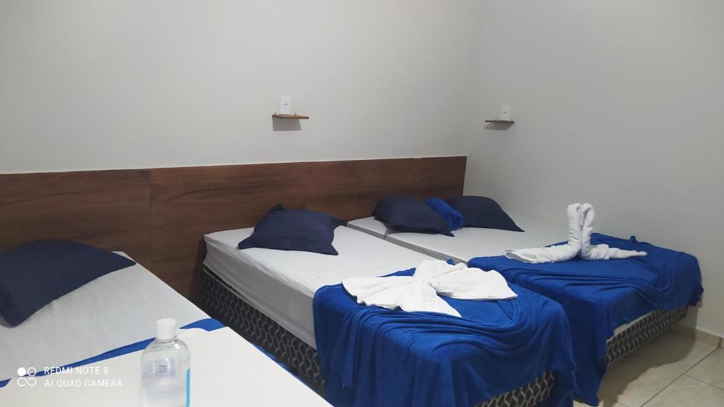 Postel nebo postele na pokoji v ubytování Pousada Quarto com frigobar,ar e garagem gratuita